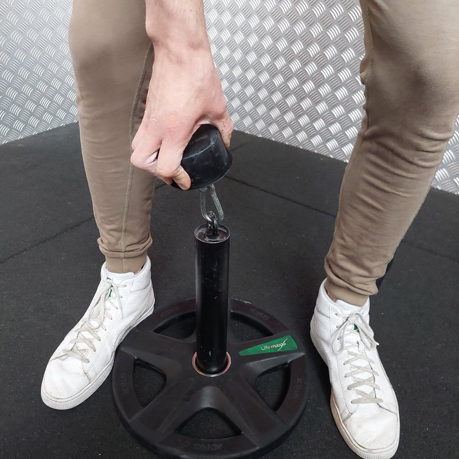 Grip Hub for strength training, made of cold hard steel with a grippy powder-coated finish, measuring 4cm high and 8cm in diameter, designed to enhance grip strength.