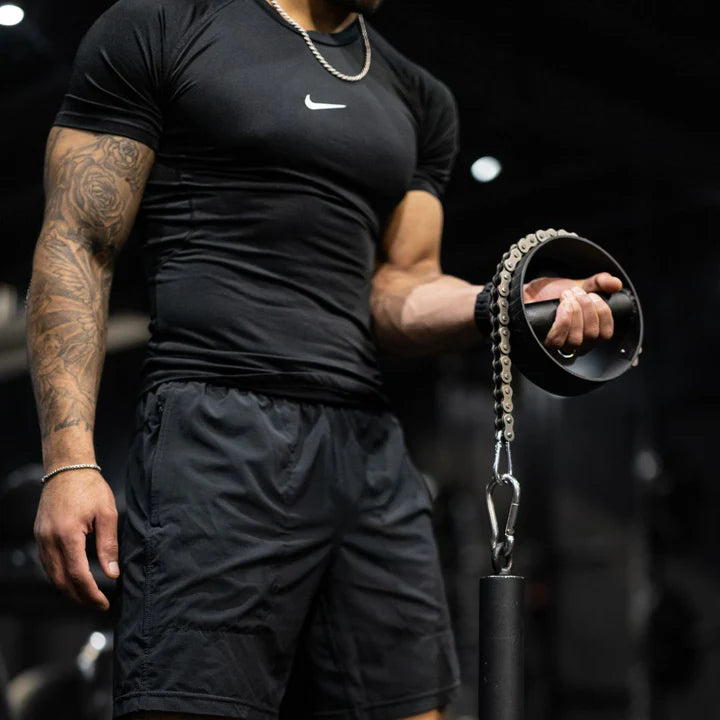 Close-up of Popeye's Pronator training tool attached to a loading pin, designed to strengthen pronation and supination muscles for forearm grip and stability.